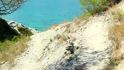 Scenic coastal view with a speedboat navigating through turquoise waters Stock Footage 344813448