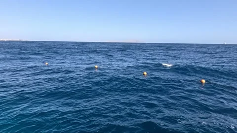 Scenic Coastal Views Featuring Luminous Buoys on Clear Blue Water, Capturing the Stock Footage 330101616