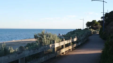 Scenic coastal walking path and wooden fence at Werribee South near a beach Видео 336035212