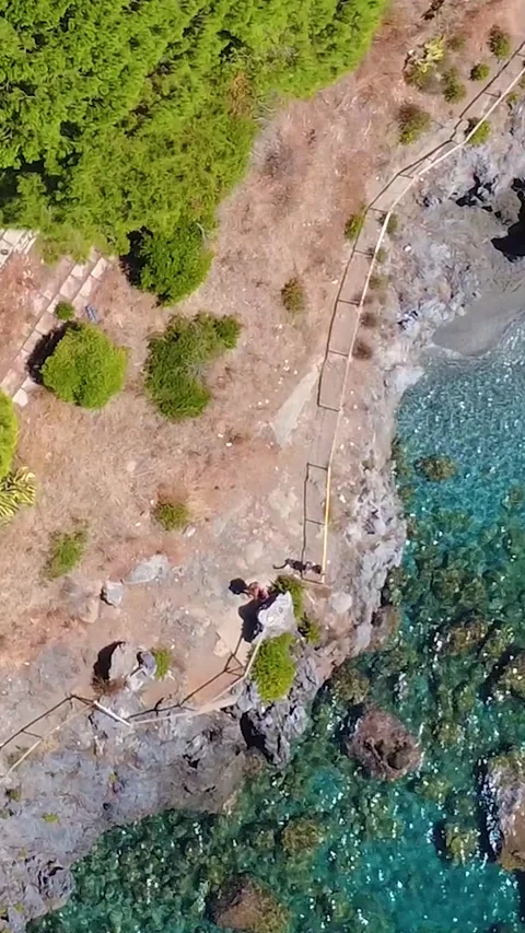 Scenic Coastline View Showcasing Clear Waters and Rocky Shores in a Tranquil Stock Footage 317750843