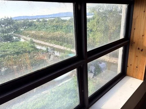 Scenic Countryside View Through a Rustic Window Stock-Fotos