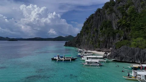 Scenic Cove with Limestone Cliffs, Turquoise Waters, and Traditional Boats Stock Footage 295792035