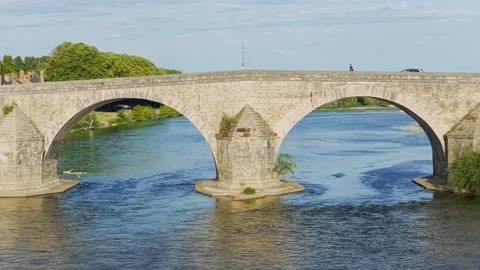 A scenic daytime view of the historic stone bridge spanning the Loire River in Stock Footage 346669845