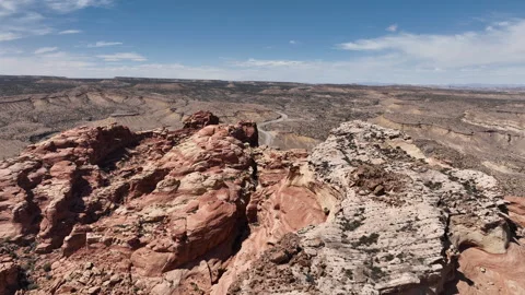 Scenic Desert Road in Spotted Wolf Canyon Beneath Sheer Rock Face Stock Footage 313749832
