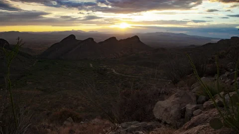 A scenic desert sunset time lapse with 4 peaks and exotic plants Stock Footage 198680996