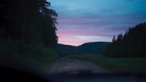 Scenic dirt road view through car windshield during peaceful twilight hour. Stock Footage 337441400