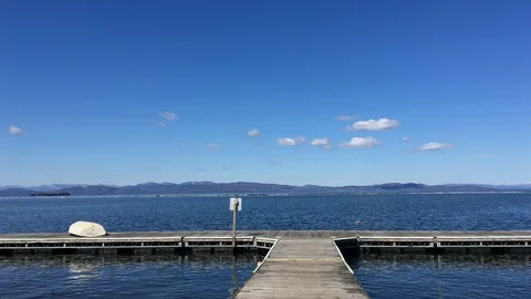Scenic Dock Overlooking Large Lake and Mountains Stock Footage 89301386