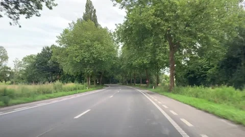 A scenic drive along a tree-lined road, a shady route in the middle of a hot sum 스톡 동영상 283757133