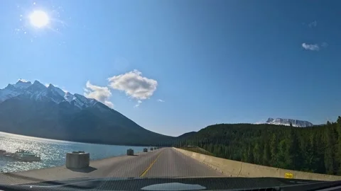 Scenic drive through Banff Canada showcasing stunning mountains and clear l.. Stock Footage 321173687
