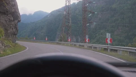 Scenic drive through mountainous forested road in daylight Video stock 301401138