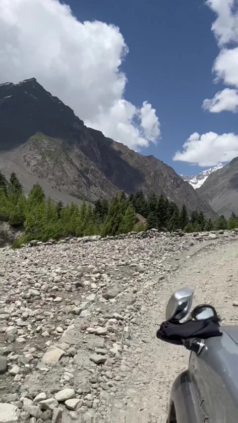 Scenic Drive Through Rugged Mountain Valley with Rocky Riverbeds and Snow Peaks Stock Footage 330136104