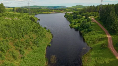 Scenic drone flight over Welsh reservoir and forest Stock Footage 337432319