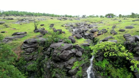 Scenic Drone Shot of a Cliffside Cascade and Meadow. Vídeo Stock 342243603
