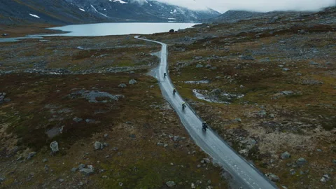 Scenic drone shot of cyclists on mountain road Stock Footage 185674341