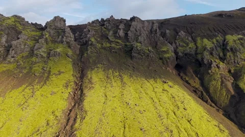 Scenic drone shot of dramatic green slopes and dark rock Stock Footage 324969375