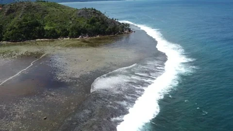 Scenic Drone View of Beach Waves, Coral Rocks, and Hills on a Clear Day Video stock 197999460