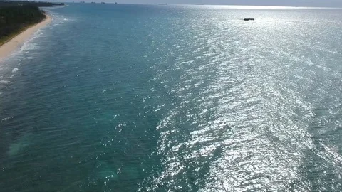 Scenic Drone View of Eight Mile Rock Shoreline and Offshore Rock, Bahamas Stock Footage 99940367