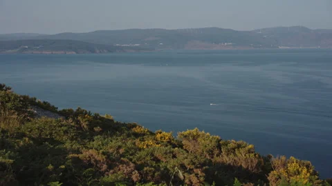 Scenic, elevated view overlooking a calm, vast bay with distant hills and a Stock Footage 344211812