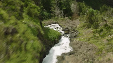 Scenic fast flowing stream in a lush green valley Stockbeeldmateriaal 333134770
