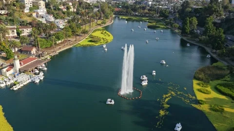 Scenic flight above Echo Park Lake featuring paddle boats, central fountain, ico Stock Footage 336634434