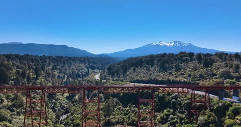 Scenic flight of dramatic viaduct, deep gorge, flanks of forested volcanoes Vídeos de archivo 171648587