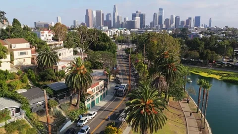 Scenic flight over Echo Park Lake revealing downtown Los Angeles skyline with lu Stock Footage 336634497