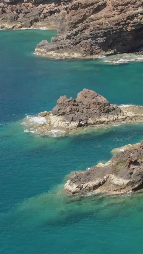 A scenic flight through the volcanic ocean shores. Rocks on Madeira, vertical Stock Footage 290048779