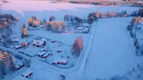Scenic fly forward over small Swedish village, cold sunny winter day, sunset Vídeos de archivo 228851419