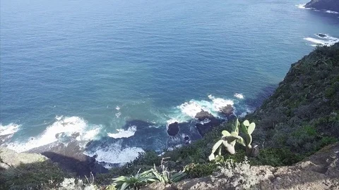 Scenic footage of dramatic and dangerous rocky cliffs jagged to ocean. Stock Footage 70453738