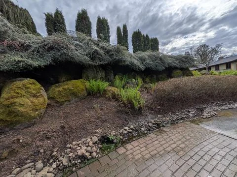 Scenic garden pathway bordered by decorative rocks, moss Stock Photos
