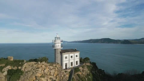 Scenic Getaria lighthouse on a cliff overlooking the ocean in Basque Country 스톡 동영상 334243558