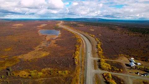 Scenic Glenn highway passing through tundra landscape in Alaska surrounded .. Stock Footage 317521690