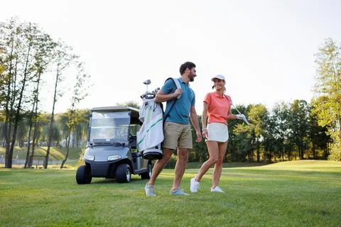 Scenic Golf Course with Active Young Couple Fotos de archivo