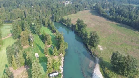 Scenic Golf Course Alongside a Clear River Stock Footage 318817680