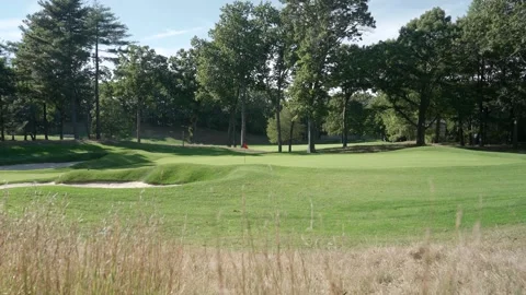 Scenic Golf Course Green with Red Flag and Sand Bunkers Видео 332686374