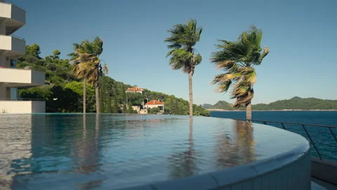 Scenic green hillside behind infinity pool - 4K UHD Vídeos de archivo 219652189