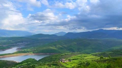 Scenic green mountains landscape with dramatic clouds and blue sky Stock Footage 310269962