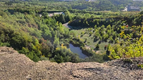 Scenic high angle view of abandoned quarry canyon with lake Video stock 346712706