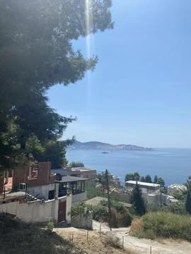 Scenic, high-angle view overlooking a coastal town bordering the calm sea Фото