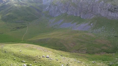 Scenic Hiking Path in a Plain with Landslides and Mountain Shadows 動画素材 303424558