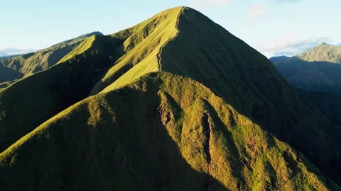 Scenic Hiking Trail Through Rolling Green Volcanic Hills in Early Morning Stock Footage 337953564