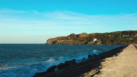 Scenic Irish coastline with rolling waves and rugged cliffs along the Howth Vídeos de archivo 336691281