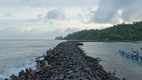 Scenic java indonesia red island beach breakwater and fishing boats Stock Footage 328919865