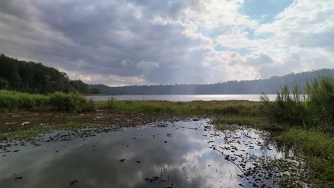 Scenic Lake Buyan with Dramatic Clouds and Sun Rays Reflection 스톡 동영상 339344262