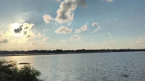 Scenic Lake Landscape at Sunset with Clouds and Golden Hour Light Stock Footage 340416270