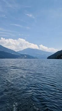 Scenic lake with subtle waves, reflections of mountains, harmonious colors Stock Photos
