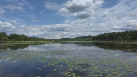 Scenic lake view with clouds reflecting in the water Stock Footage 318770161