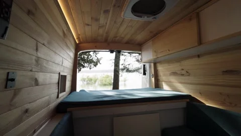 Scenic lake view from inside a rustic camper van Stock Footage 344824329