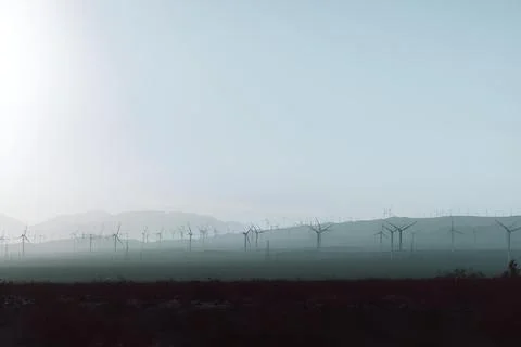 Scenic landscape with an array of wind turbines against a backdrop of an overcas Foto stock