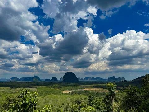 Scenic Landscape with Dramatic Clouds and Lush Greenery Stock Photos